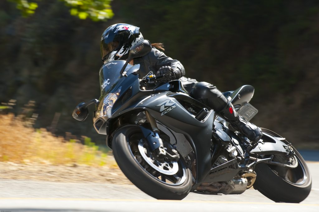 Profiles of a Female Motorcyclist Meet Nadine leaning into a turn