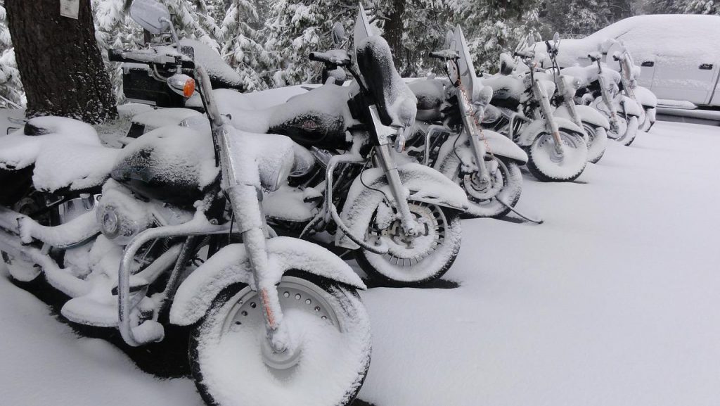 Season to start Motorcycling - Motorcycles parked covered in snow